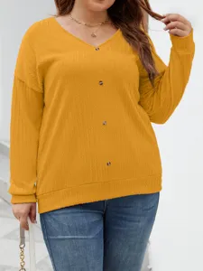 Close-up detail of a mustard yellow V-neck ribbed knit sweater with buttons for women.