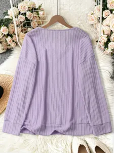 Detailed view of casual long sleeve purple knitted sweater featuring vertical rib pattern.