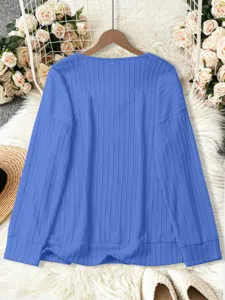 Blue ribbed knit sweater detail, loose fit casual long sleeve knitwear texture showcase.