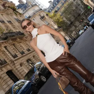 Women white halter neck sleeveless top with gold ring detail, elegant summer fashion blouse.