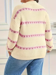 Detailed view of a beige knit sweater featuring pink heart pattern stripes and round neck.