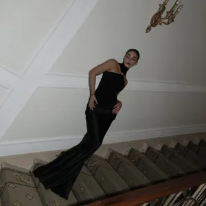 Elegant black sleeveless bodycon dress with gold ring detail, perfect for evening parties.