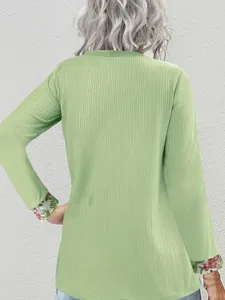Women casual long sleeve ribbed top with floral cuffs, elegant green stylish apparel detail.