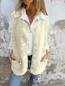 Close-up view of a cozy cream sherpa fleece vest showcasing soft texture, button closure.