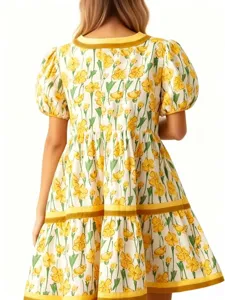 Detailed view of the elegant yellow floral puff sleeve tiered dress back design showcase.