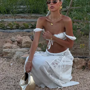 Women white sexy crop top and lace long skirt beach cover up set for summer holiday vacation.