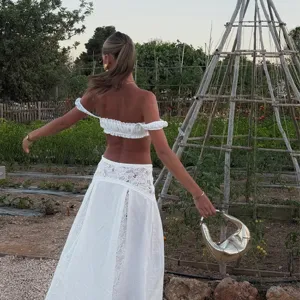 Details of the white off-shoulder crop top and lace beach skirt bikini cover-up set for women.
