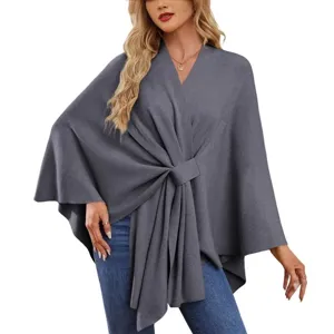 Elegant solid color knit poncho cape top for women, stylish knotted front design, cozy.