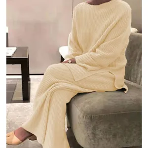 Cozy knit sweater detail, soft fabric texture close-up view in modern indoor setting.