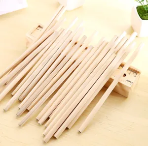 Detailed view of unsharpened natural wood hexagonal pencils stacked on a wooden desk.