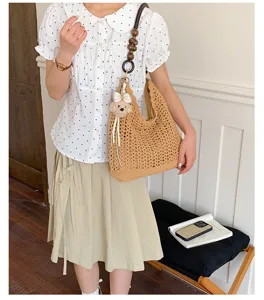 Detailed view of a Korean style hollow crochet woven shoulder bag featuring a bead strap design