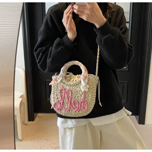 Stylish handmade straw bucket bag with pink Hello embroidery and floral scarf handle