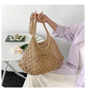 Detailed view of a handmade beige woven hollow tote bag with intricate knotting details