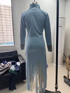 Back detail of light blue long-sleeve fringe dress with vintage cuff embroidery.