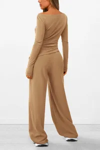 Detailed back view of casual autumn set, asymmetric long sleeve top with wide leg pants.