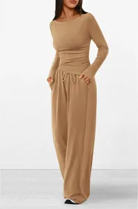 Detail view of the asymmetric long-sleeve top and wide-leg trousers lounge set in beige color.
