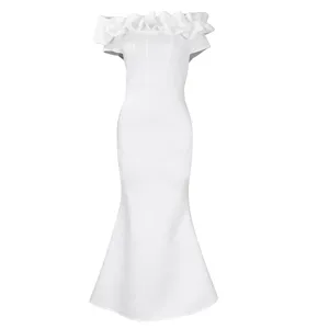 Close-up detail of white off-the-shoulder ruffle trim and slim mermaid evening dress hem.