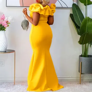 Detailed view of yellow off-shoulder ruffle mermaid evening dress in elegant indoor setting.