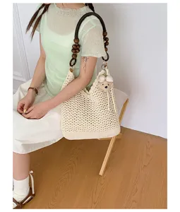 Handmade woven tote bag featuring a wooden bead shoulder strap and a cute plush bear charm