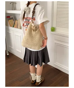 Casual beige hollow knit shoulder bag with wooden beads strap and small bear pendant