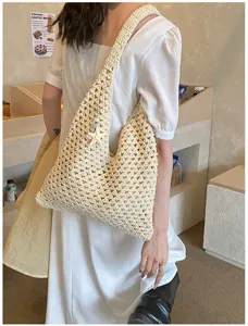 Detailed view of a cream hand-woven hollow knit tote bag for summer beach style