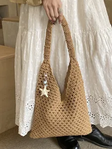 Handmade crochet hollow beach tote bag for women, perfect for summer style in brown