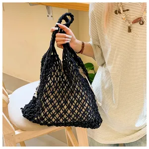 Chic black cotton rope woven tote bag with inner drawstring shown in lifestyle setting