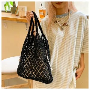 Handmade black woven cotton rope tote bag with drawstring inner lining on model