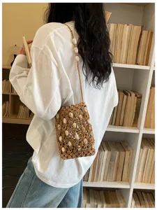 Handmade woven crossbody phone bag with shell beads for beach holiday style.