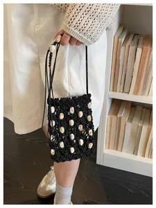Detail of black beaded hollow mobile phone bag with shell accents for beach vacations
