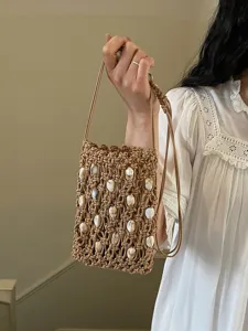 Handmade woven hollow beaded phone bag with shell accents for beach vacation style