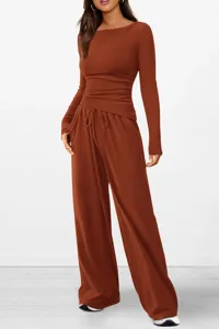Detailed view of the rust brown asymmetric long sleeve top and wide leg lounge pants set.