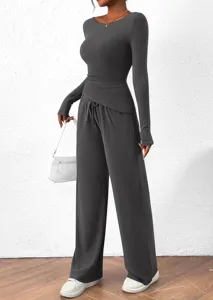 Detail view of women's autumn long sleeve asymmetrical t-shirt and wide leg pants set.