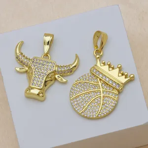Detailed view of pavé cubic zirconia bull head and crown basketball gold pendants