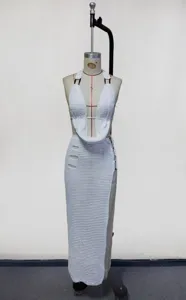 White crochet halter crop top and maxi skirt cover-up set, perfect for beach holiday.