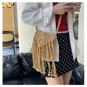 Detailed view of a handmade beige macramé fringe shoulder bag for summer vacation style