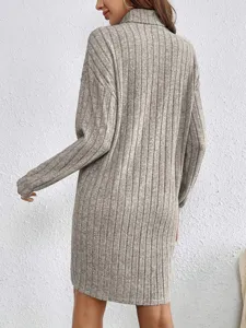 Details of the grey turtleneck long sleeve ribbed knit dress, showing sleeve and back texture.