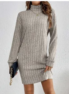 Detailed view of the grey high-neck ribbed knit dress, featuring long sleeves and cozy texture.