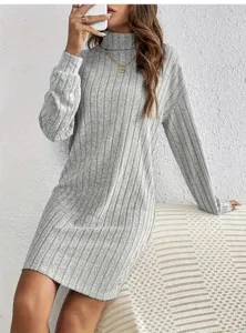 Detail shot of grey ribbed knit sweater dress, featuring a cozy turtleneck and long sleeves.