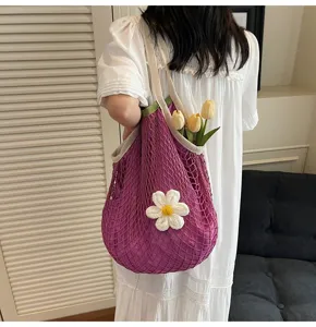Stylish purple crochet mesh tote bag with a white flower for summer beach vacation outfits