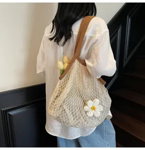 Detailed view of summer mesh tote bag with flower decor and woven straps.