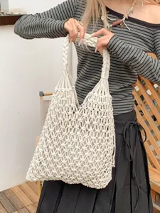 Minimalist hand-woven cotton rope mesh tote bag with artistic hollow out design in cream white