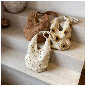 Detailed shot of handmade crochet cotton shoulder bags with sunflower pattern designs