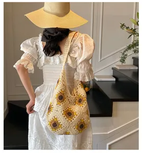 Back view of a handmade crochet sunflower shoulder bag with cotton thread details