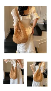 Detailed macro view of handmade brown crochet straw shoulder bag featuring hollow pattern
