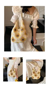 Handmade crochet shoulder bag featuring sunflower pattern displayed in lifestyle setting
