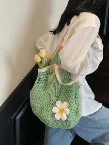 Green mesh tote bag with white crochet flower decoration for summer beach vacations