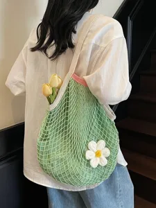 Handcrafted green mesh crochet tote bag with white flower charm for summer beach vacation