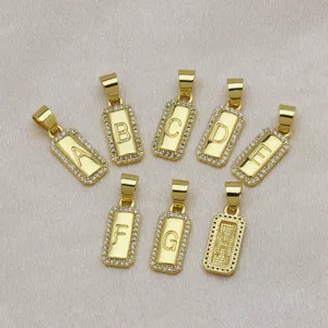 Detail view of 18K gold plated square alphabet pendants with sparkling zircon borders