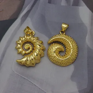 Close-up of 18K gold plated marine pendants showing textured and smooth shell details.